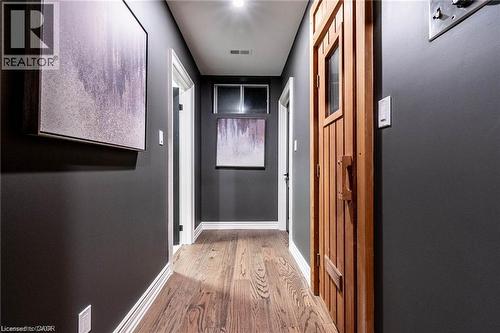 Hallway featuring wood-finish flooring and dark gray walls - 76 Adriatic Boulevard, Hamilton, ON - Indoor Photo Showing Other Room
