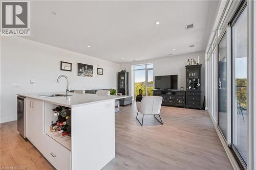Open-concept living space featuring wood-finish flooring and extensive natural light - 15 Glebe Street Unit# 902, Cambridge, ON - Indoor Photo Showing Other Room