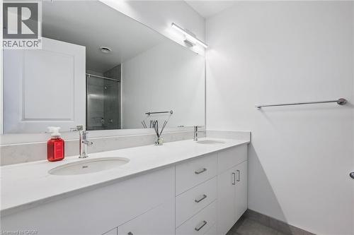 Double vanity with white cabinetry, integrated sinks, and polished chrome fixtures - 15 Glebe Street Unit# 902, Cambridge, ON - Indoor Photo Showing Bathroom
