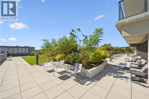 Expansive rooftop patio featuring a combination of paver flooring and green space - 15 Glebe Street Unit# 902, Cambridge, ON - Outdoor