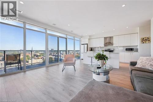 Open-concept living space featuring expansive floor-to-ceiling windows, light wood-finish flooring, and recessed lighting - 15 Glebe Street Unit# 902, Cambridge, ON - Indoor Photo Showing Living Room
