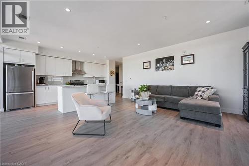Open-concept living space featuring wood-finish flooring throughout - 15 Glebe Street Unit# 902, Cambridge, ON - Indoor
