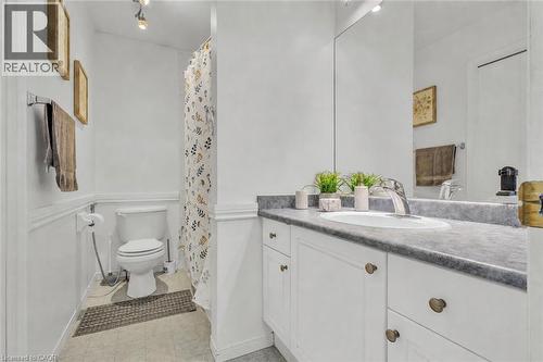 Bathroom featuring a white vanity with paneled doors, a rectangular undermount sink, and a grey countertop - 425 Erinbrook Drive, Kitchener, ON - Indoor Photo Showing Bathroom