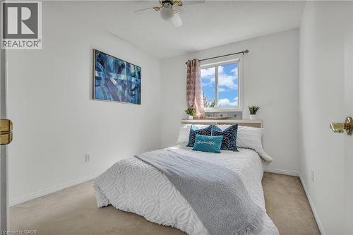 Bright room featuring a window with white trim, a ceiling fan, and light-toned carpet flooring - 425 Erinbrook Drive, Kitchener, ON - Indoor Photo Showing Bedroom