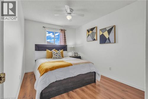 Bedroom featuring wood-finish flooring, a window with natural light, and a ceiling fan with integrated lighting - 425 Erinbrook Drive, Kitchener, ON - Indoor Photo Showing Bedroom