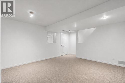 Spacious room featuring neutral carpet flooring, white painted walls, and recessed lighting - 425 Erinbrook Drive, Kitchener, ON - Indoor Photo Showing Other Room