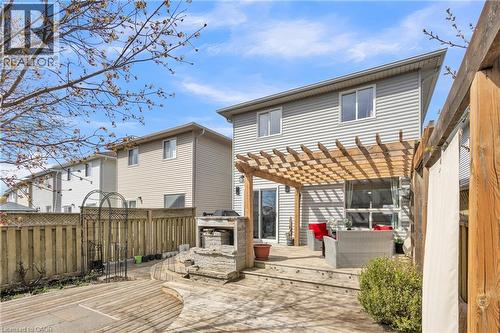 Backyard featuring a multi-level wood deck, a stone-built outdoor grill station, and a wood pergola - 425 Erinbrook Drive, Kitchener, ON - Outdoor With Deck Patio Veranda