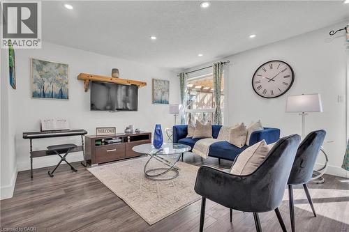 Spacious living area featuring recessed lighting, dark wood-finish flooring, and light-colored walls - 425 Erinbrook Drive, Kitchener, ON - Indoor Photo Showing Living Room