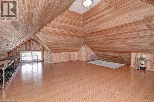 Expansive loft area featuring wood-finish flooring, wood plank walls, and a vaulted wood plank ceiling - 147 Courtland Avenue E, Kitchener, ON - Indoor Photo Showing Other Room