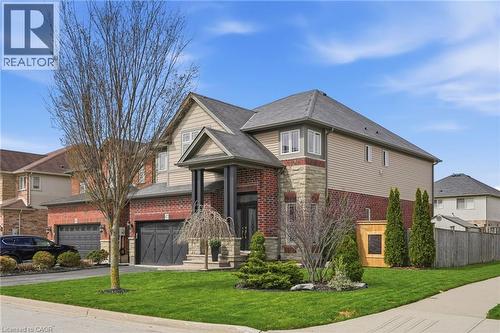 Two-story residence featuring a brick and stone facade with siding accents - 47 Winners Way, Binbrook, ON - Outdoor