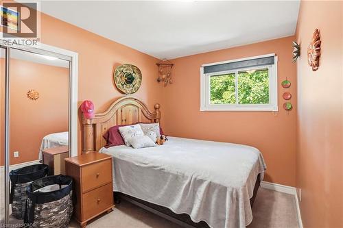 Bedroom featuring a single window, mirrored closet doors, carpet flooring, and painted walls - 25 Saveryn Road, Hamilton, ON - Indoor Photo Showing Bedroom