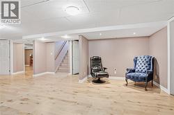 Spacious room featuring light wood-finish flooring, recessed lighting, and a drop ceiling - 