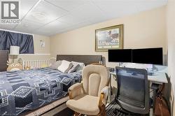 Room featuring neutral wall tones, a drop ceiling, and carpeted flooring - 