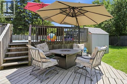 Wood deck featuring a fire pit table, stairs to a lower level, and a surrounding privacy fence - 25 Saveryn Road, Hamilton, ON - Outdoor With Deck Patio Veranda With Exterior