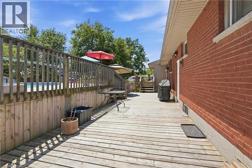 Expansive wood deck with a privacy railing overlooking an above-ground pool - 25 Saveryn Road, Hamilton, ON - Outdoor With Exterior