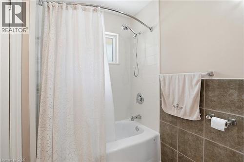 Full-size bathtub with white subway tile surround and a chrome showerhead - 25 Saveryn Road, Hamilton, ON - Indoor Photo Showing Bathroom
