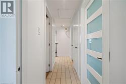 Hallway featuring wood-finish flooring, white walls, and recessed lighting - 