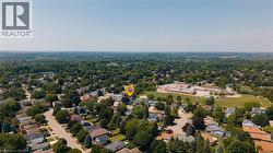 Expansive aerial perspective showcasing a residential neighborhood with abundant mature trees and a clear sky - 