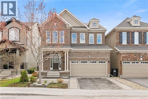 Brick facade home with a covered front porch, dormer windows, and an integrated two-car garage - 96 Damselfly Way, Ottawa, ON - Outdoor With Facade