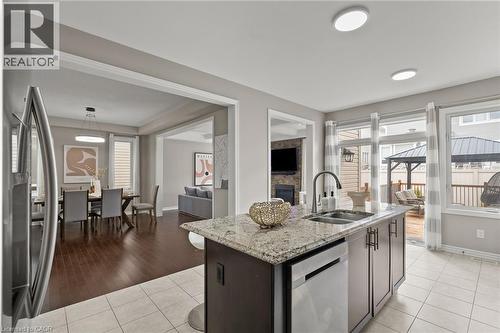 Kitchen island with granite countertop and stainless steel sink - 96 Damselfly Way, Ottawa, ON - Indoor Photo Showing Kitchen With Double Sink