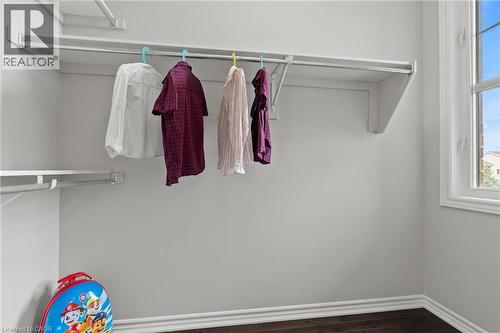 Interior closet space featuring built-in white shelving and hanging rods - 96 Damselfly Way, Ottawa, ON - Indoor With Storage