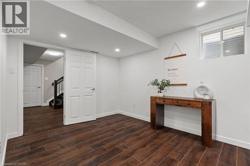 Expansive room featuring wood-look tile flooring, white baseboards, and recessed lighting - 96 Damselfly Way, Ottawa, ON - Indoor