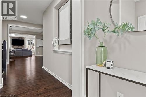Rich wood-finish flooring extending through the hallway - 96 Damselfly Way, Ottawa, ON - Indoor Photo Showing Other Room