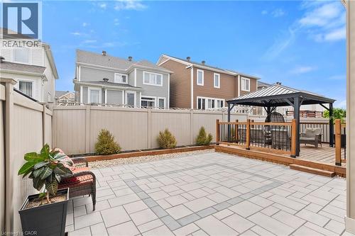 Expansive outdoor space featuring a raised wooden deck with a gazebo, paver patio, and full-height privacy fencing - 96 Damselfly Way, Ottawa, ON - Outdoor With Deck Patio Veranda