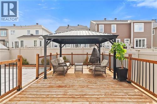 Expansive wooden deck featuring a built-in pergola, complete with a surrounding wood and metal railing - 96 Damselfly Way, Ottawa, ON - Outdoor With Deck Patio Veranda With Exterior