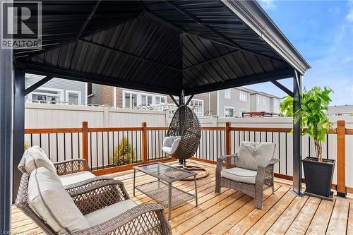 Expansive outdoor deck featuring wood-finish flooring and a black metal gazebo - 96 Damselfly Way, Ottawa, ON - Outdoor With Deck Patio Veranda With Exterior
