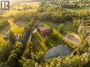 Expansive property featuring a private pond with a fountain and dock, extensive landscaping with mature trees, a long gravel driveway, and a residential structure - 12613 Second Line, Milton, ON  - Outdoor With View 