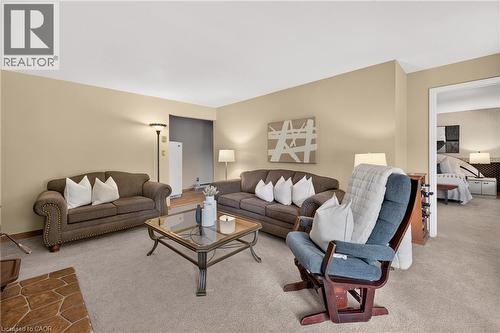Warm-toned walls complement plush carpeting throughout this inviting living space - 12613 Second Line, Milton, ON - Indoor Photo Showing Living Room