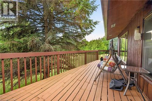 Wood-finish deck with a perimeter railing and outdoor wall-mounted lighting fixture - 12613 Second Line, Milton, ON - Outdoor With Deck Patio Veranda