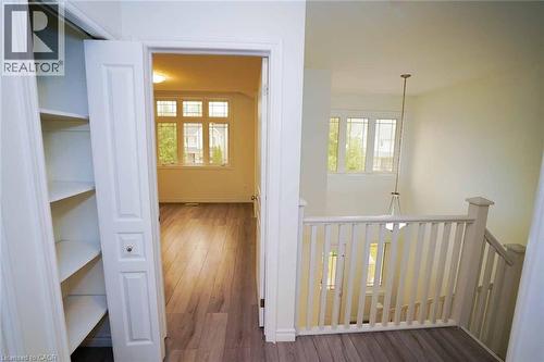 Bright interior featuring wood-finish flooring, white walls, and a multi-pane window - 18 Heritage Drive, Guelph, ON - Indoor Photo Showing Other Room