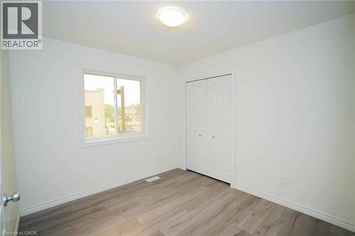 Room featuring light wood-finish flooring, white walls, and a white ceiling with a flush-mount light fixture - 18 Heritage Drive, Guelph, ON - Indoor Photo Showing Other Room