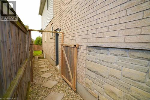 Exterior siding featuring light-toned brick and a stone veneer foundation - 18 Heritage Drive, Guelph, ON - Outdoor With Exterior
