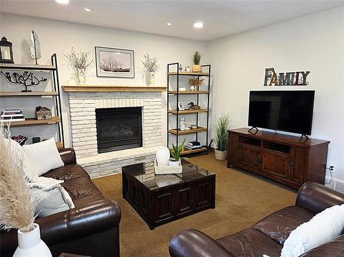 106 River Dr, Selkirk, MB - Indoor Photo Showing Living Room With Fireplace
