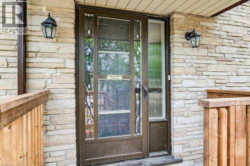 Stone veneer exterior with a storm door featuring decorative glass inserts and a full-length sidelight - 109 White Oak Place, Waterloo, ON -  With Exterior