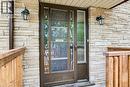 Stone veneer exterior with a storm door featuring decorative glass inserts and a full-length sidelight - 109 White Oak Place, Waterloo, ON  -  With Exterior 