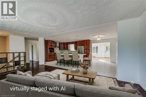 Open-concept living area with dark wood-finish flooring, a textured ceiling, and recessed lighting - 109 White Oak Place, Waterloo, ON - Indoor Photo Showing Living Room