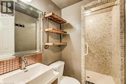 Bathroom featuring a walk-in shower with mosaic tile, custom wood shelving, a contemporary vanity with an integrated sink, a rectangular mirror, and a copper tile backsplash - 