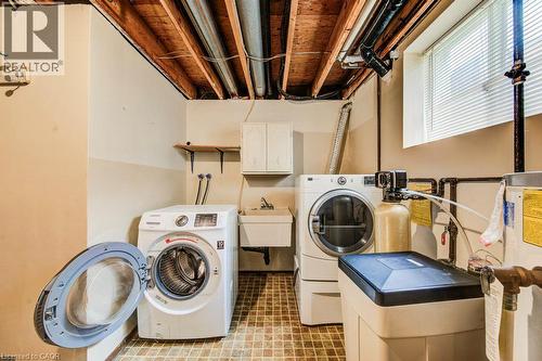 Dedicated laundry area with a utility sink and upper cabinetry - 109 White Oak Place, Waterloo, ON - Indoor Photo Showing Laundry Room