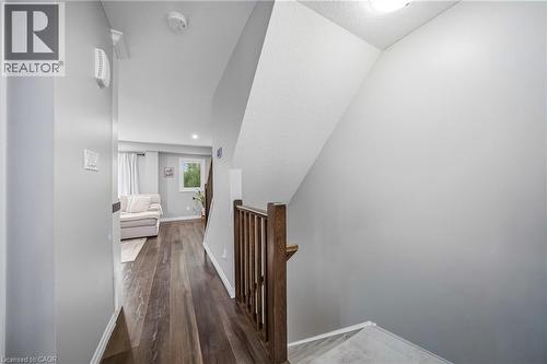 Hallway with wood-finish flooring, light grey painted walls, and white trim - 750 Lawrence Street Unit# 38, Cambridge, ON - Indoor Photo Showing Other Room