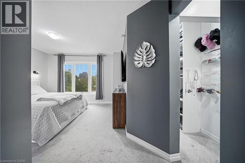 Carpeted room with a multi-pane window, flush-mount ceiling light, and white baseboards - 750 Lawrence Street Unit# 38, Cambridge, ON - Indoor Photo Showing Bedroom