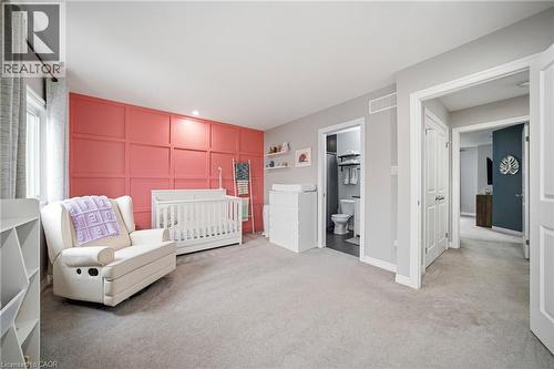 Room featuring a decorative panel accent wall, plush carpeting, recessed lighting, and a window with roller blinds - 750 Lawrence Street Unit# 38, Cambridge, ON - Indoor