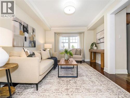 Living area featuring dark wood-finish flooring, white trim, and crown molding - 656 Frank Place, Milton, ON - Indoor Photo Showing Living Room