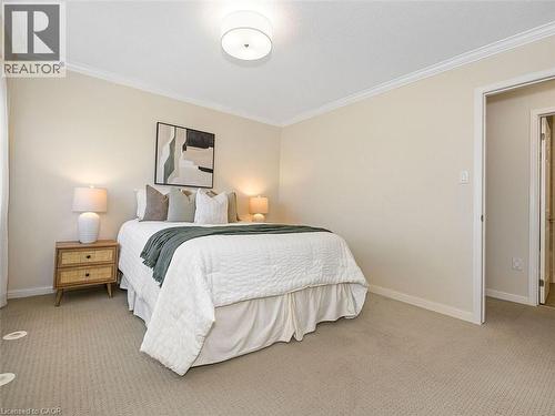 Carpeted bedroom featuring neutral wall tones and white crown molding - 656 Frank Place, Milton, ON - Indoor Photo Showing Bedroom