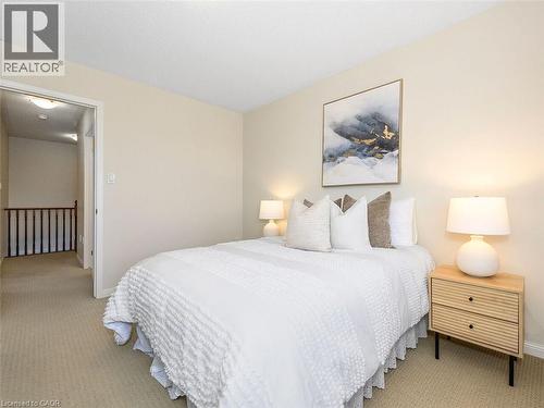 Carpeted bedroom with neutral wall tones and a textured ceiling - 656 Frank Place, Milton, ON - Indoor Photo Showing Bedroom