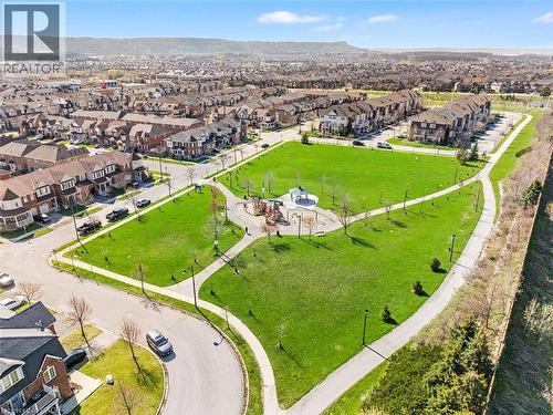 Expansive community park featuring green space, paved walking paths, and a children's play area with a covered gazebo - 656 Frank Place, Milton, ON - Outdoor With View