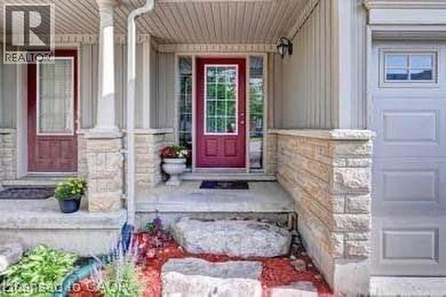 Front entry featuring a vibrant red door with glass inserts, flanked by full-length sidelights - 175 David Bergey Drive Unit# L74, Kitchener, ON - Outdoor
